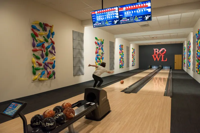Private bowling lane with colorful pin artwork on the walls