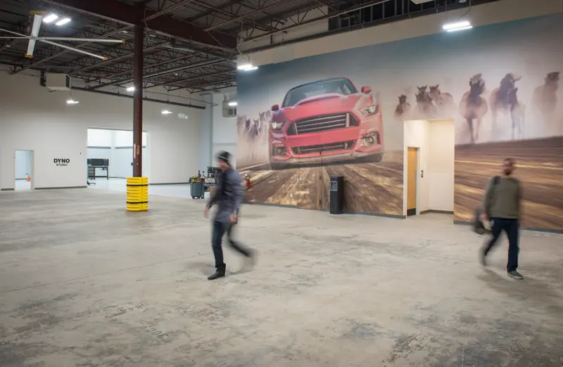 Large open studio space with a car mural on the wall