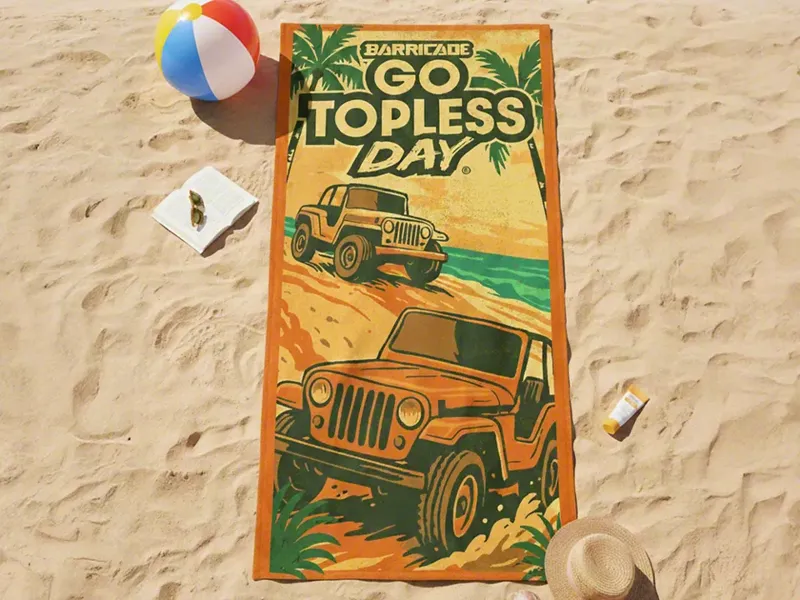 Go Topless Day beach towel with a retro Jeep and palm tree illustration